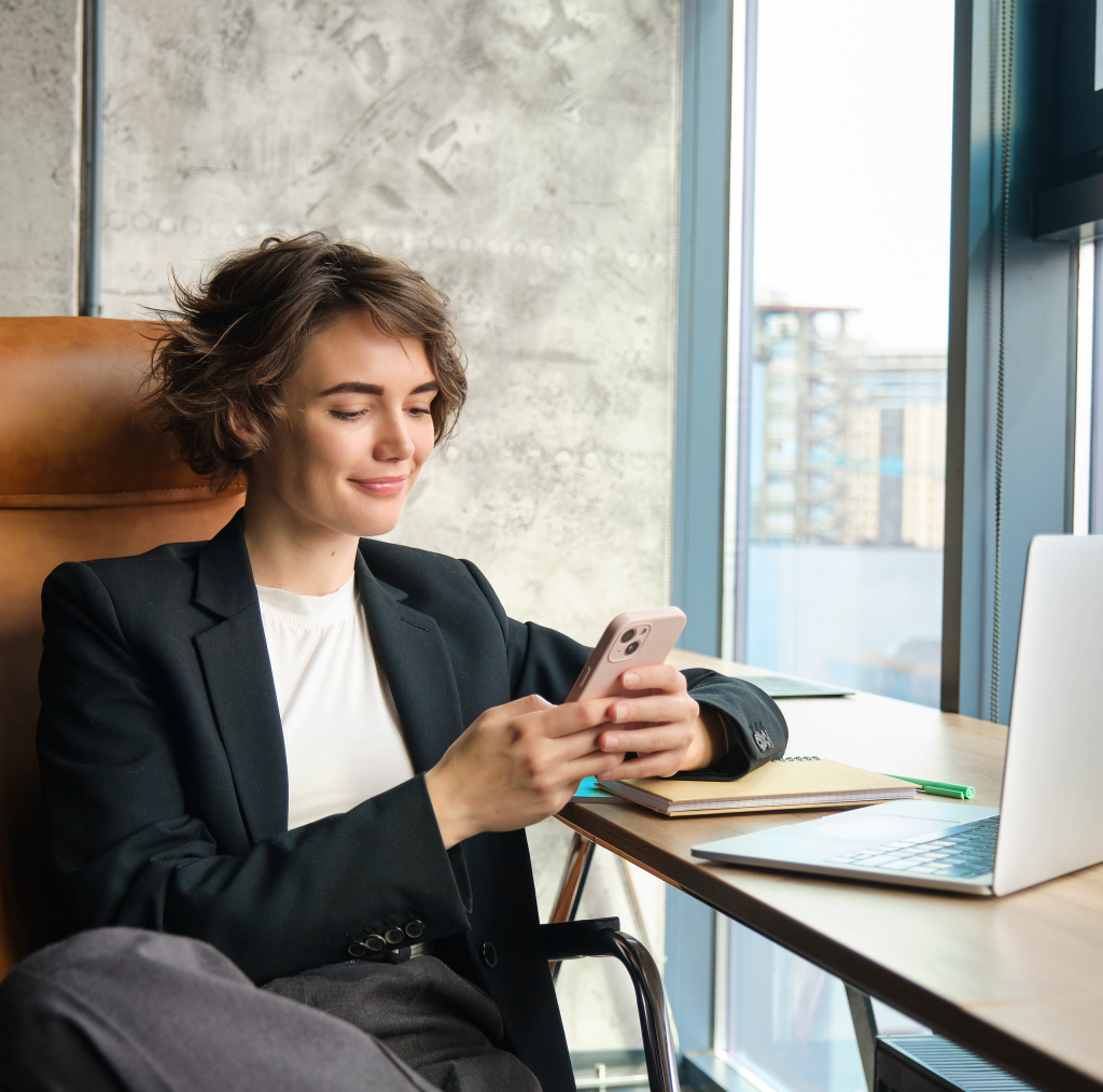portrait businesswoman resting her office front window using mobile phone sitting with.jpg